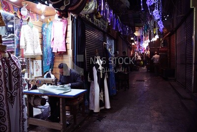 Man working in the profession of sewing, a sewing shop, the skill of sewing and mastering the tailoring of youthful clothes