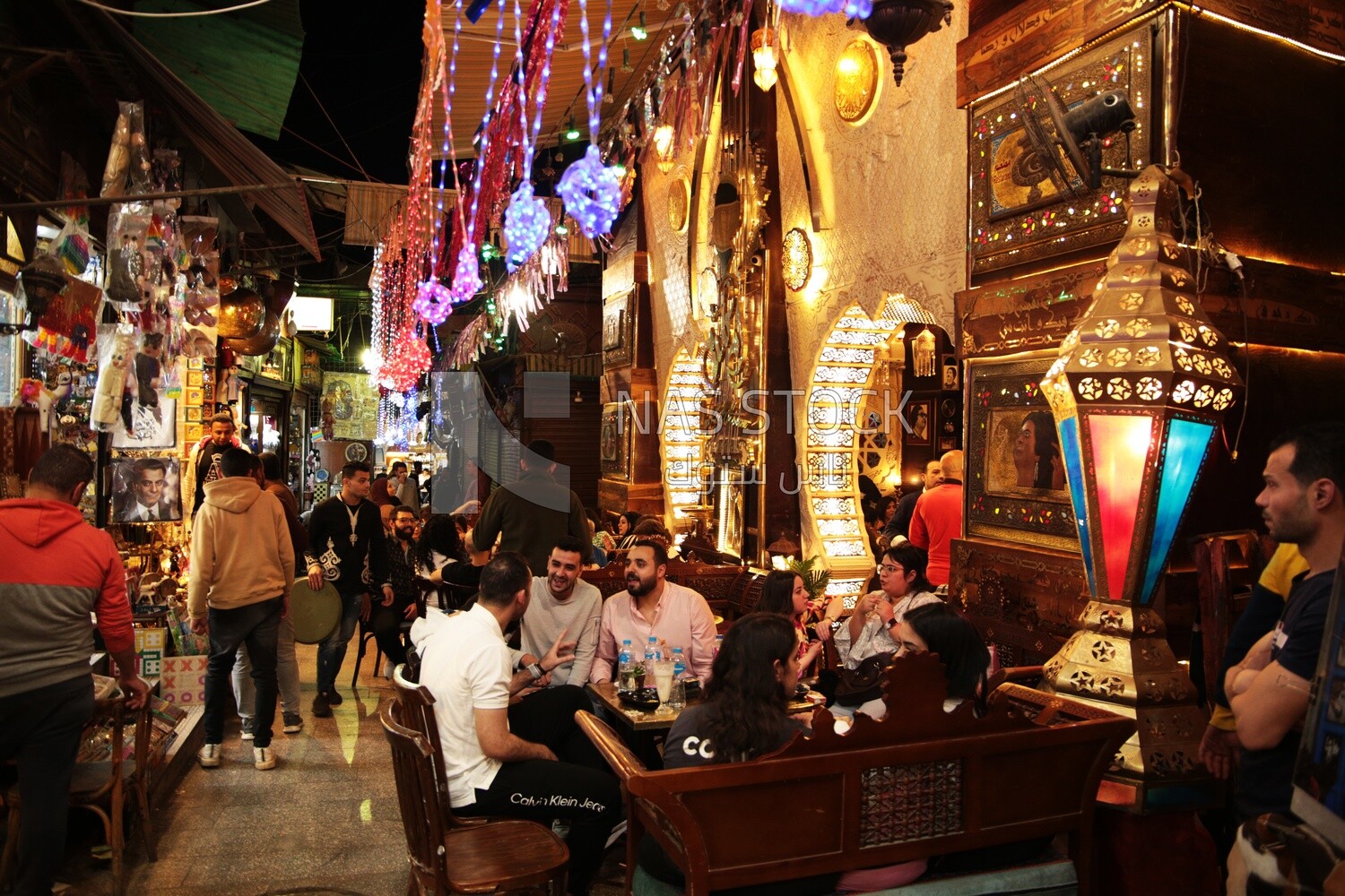 People sitting in a street coffee shop, Ramadan