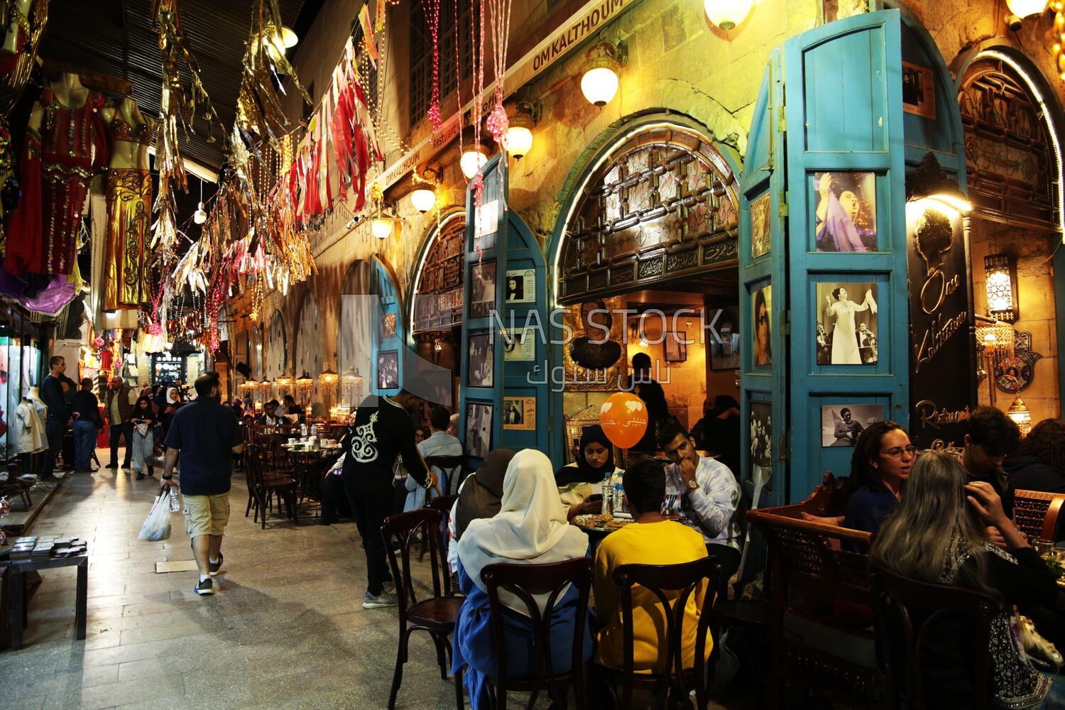 People sitting in a street coffee shop, Ramadan