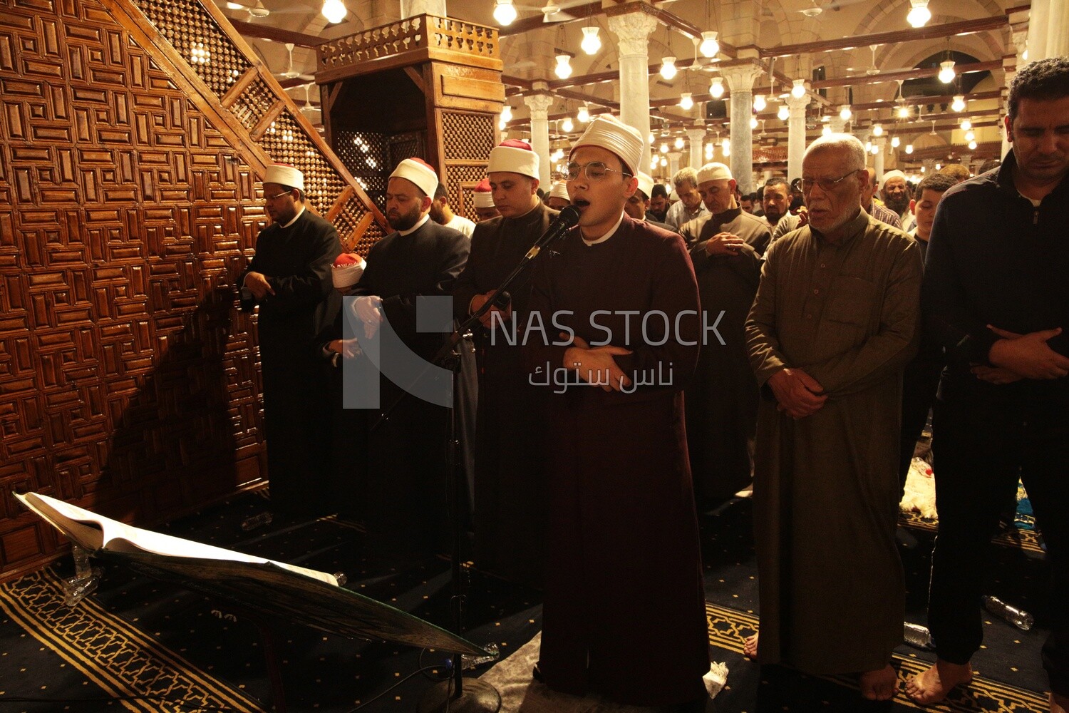 Worshipers praying in a mosque, performing the obligatory prayer in the mosque, worship and draw close to God