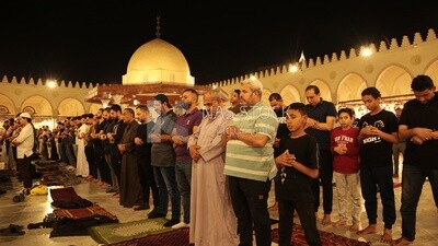 Worshipers praying in a mosque, performing the obligatory prayer in the mosque, worship and draw close to God