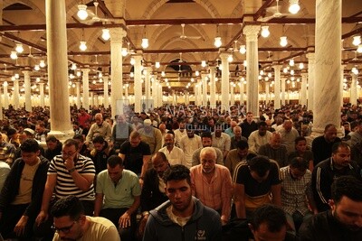 Worshipers praying in a mosque, performing the obligatory prayer in the mosque, worship and draw close to God