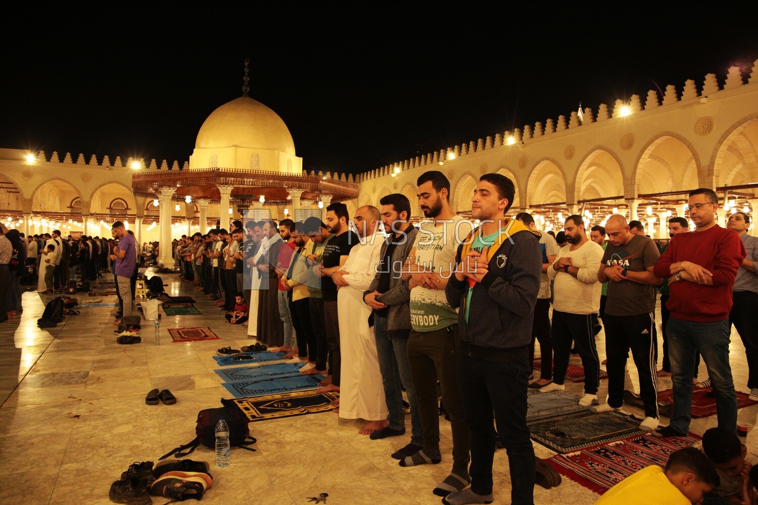 Worshipers praying in a mosque, performing the obligatory prayer in the mosque, worship and draw close to God