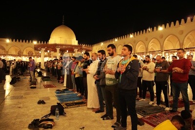 Worshipers praying in a mosque, performing the obligatory prayer in the mosque, worship and draw close to God
