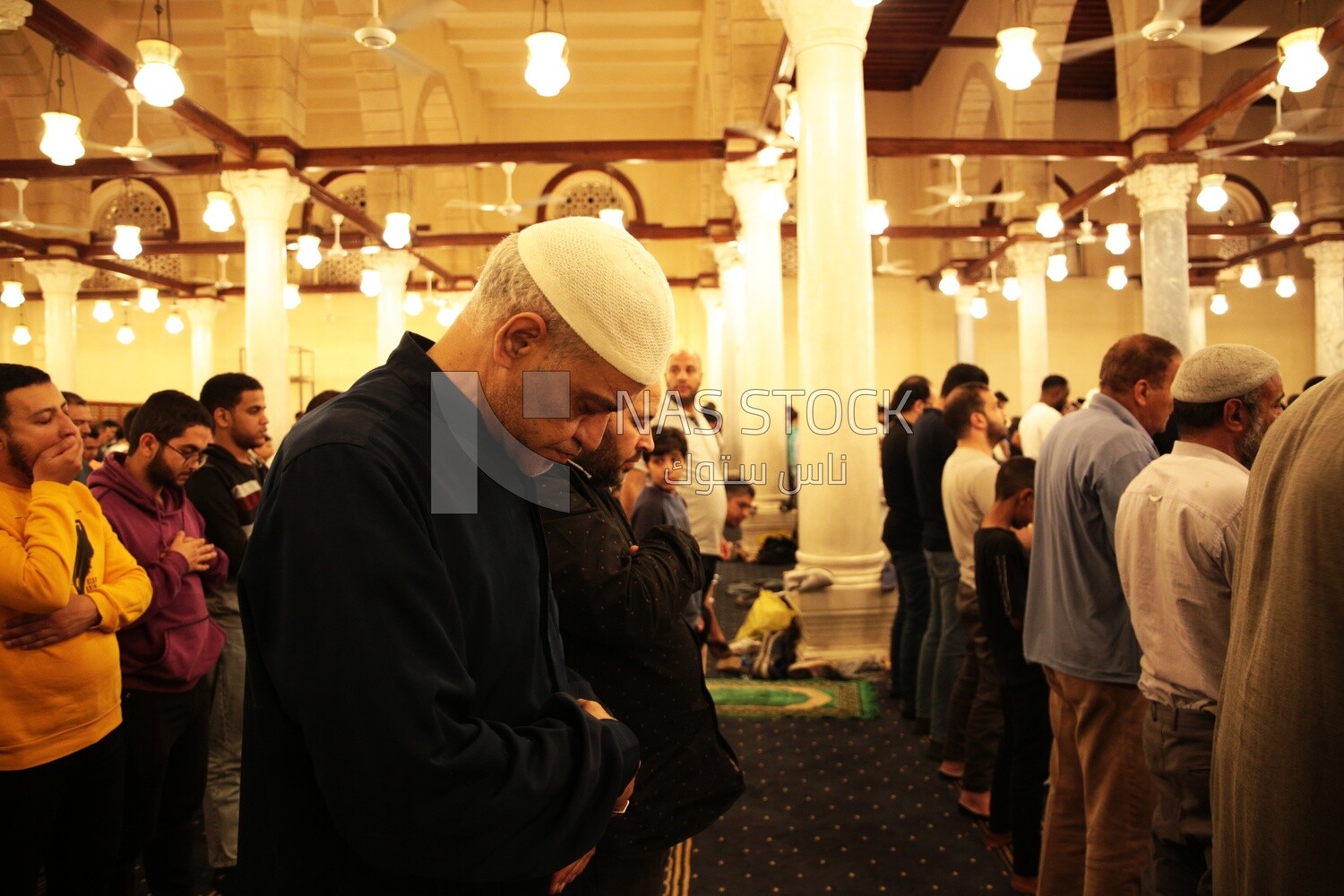 Worshipers praying in a mosque, performing the obligatory prayer in the mosque, worship and draw close to God