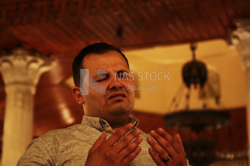 Man in the mosque, praying to God, praying on the prayer rug, performing the obligatory prayer in the mosque, worship and draw close to God