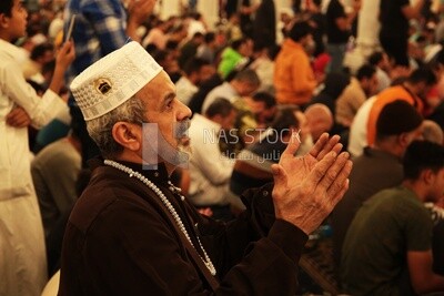Man in the mosque, praying to God, praying on the prayer rug, performing the obligatory prayer in the mosque, worship and draw close to God