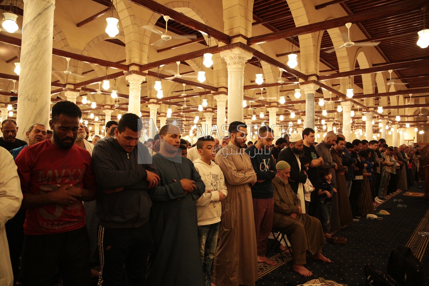 Worshipers praying in a mosque, performing the obligatory prayer in the mosque, worship and draw close to God