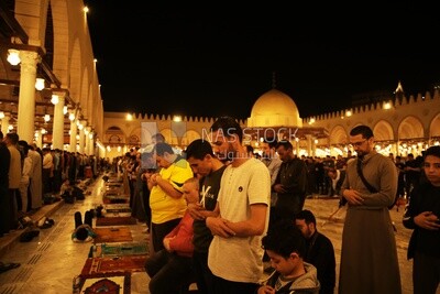 Worshipers praying in a mosque, performing the obligatory prayer in the mosque, worship and draw close to God