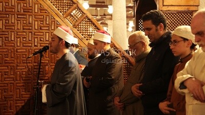 Worshipers praying in a mosque, performing the obligatory prayer in the mosque, worship and draw close to God