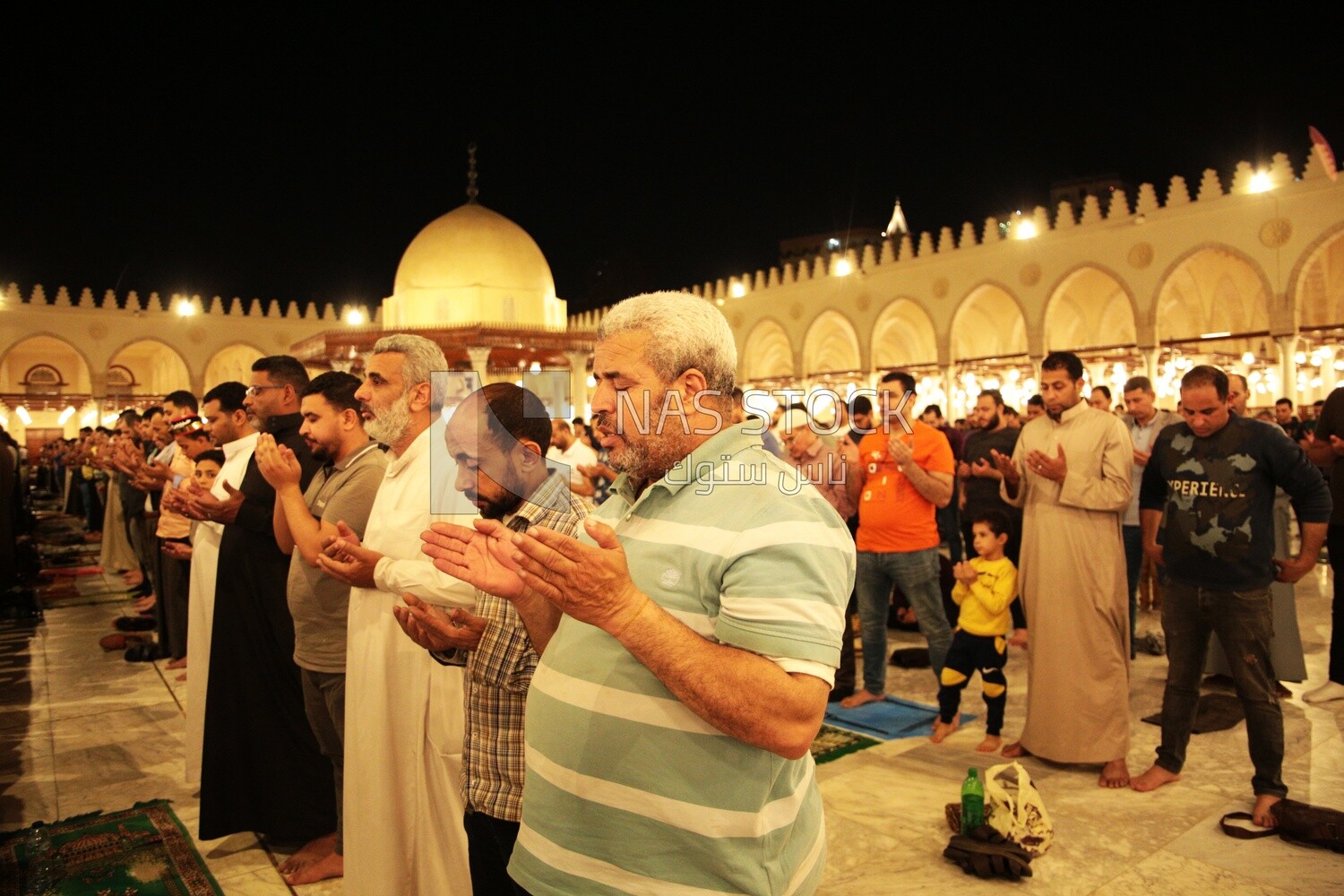 Worshipers praying in a mosque, performing the obligatory prayer in the mosque, worship and draw close to God