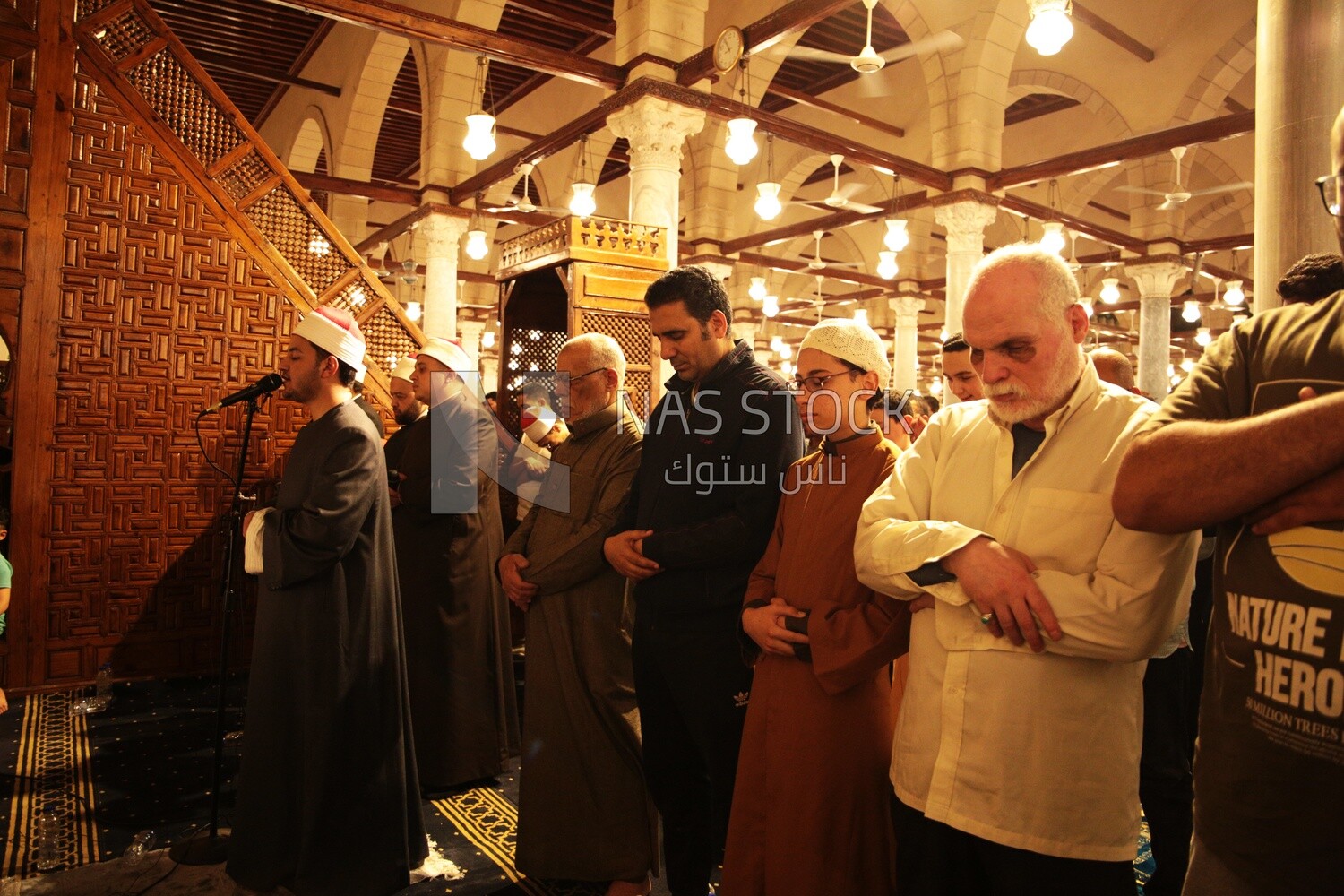 Worshipers praying in a mosque, performing the obligatory prayer in the mosque, worship and draw close to God