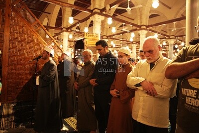 Worshipers praying in a mosque, performing the obligatory prayer in the mosque, worship and draw close to God