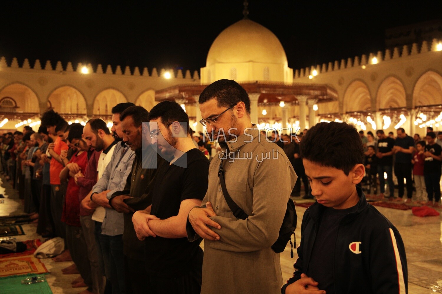 Worshipers praying in a mosque, performing the obligatory prayer in the mosque, worship and draw close to God