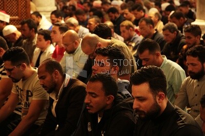 Worshipers praying in a mosque, performing the obligatory prayer in the mosque, worship and draw close to God