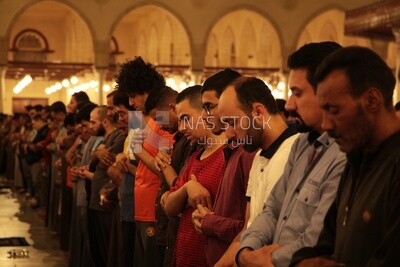 Worshipers praying in a mosque, performing the obligatory prayer in the mosque, worship and draw close to God