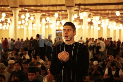Man in the mosque, praying to God, praying on the prayer rug, performing the obligatory prayer in the mosque, worship and draw close to God