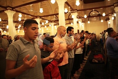Worshipers praying in a mosque, performing the obligatory prayer in the mosque, worship and draw close to God