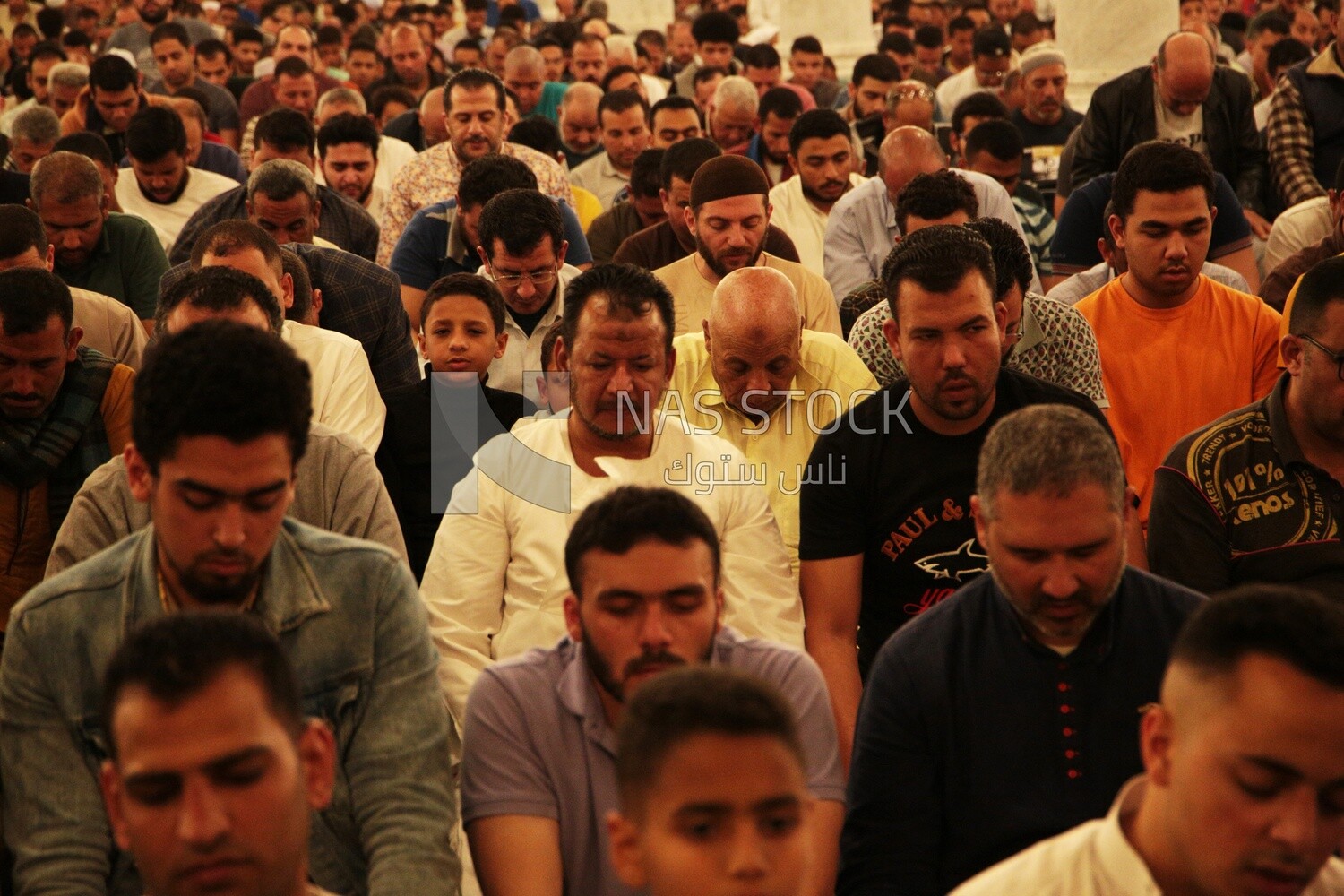 Worshipers praying in a mosque, performing the obligatory prayer in the mosque, worship and draw close to God