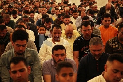Worshipers praying in a mosque, performing the obligatory prayer in the mosque, worship and draw close to God