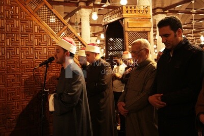 Imam of the mosque praying with people Worshipers praying in a mosque, performing the obligatory prayer in the mosque, worship and draw close to God