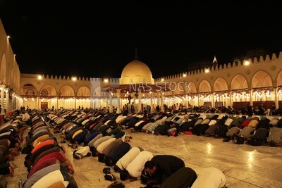Worshipers praying in a mosque, performing the obligatory prayer in the mosque, worship and draw close to God