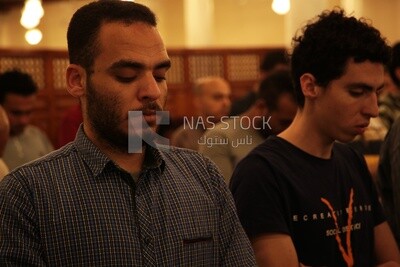 Worshipers praying in a mosque, performing the obligatory prayer in the mosque, worship and draw close to God