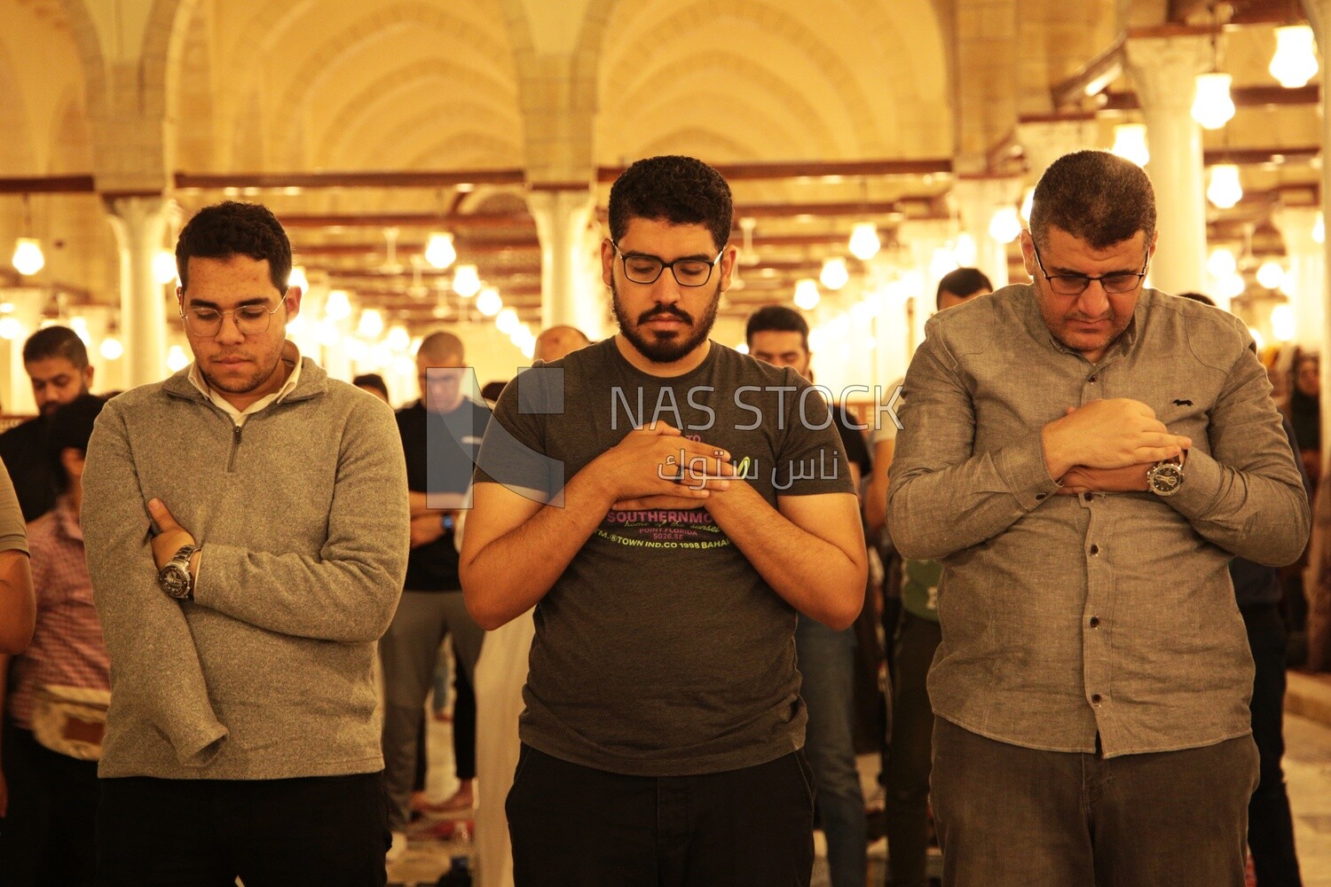 Worshipers praying in a mosque, performing the obligatory prayer in the mosque, worship and draw close to God