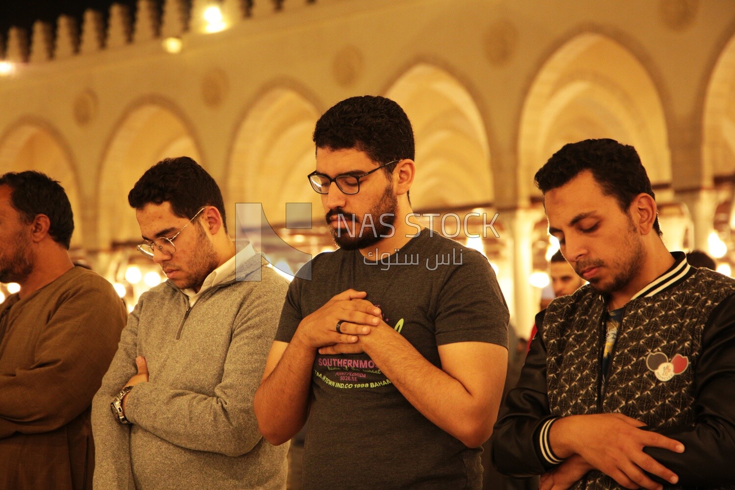 Worshipers praying in a mosque, performing the obligatory prayer in the mosque, worship and draw close to God