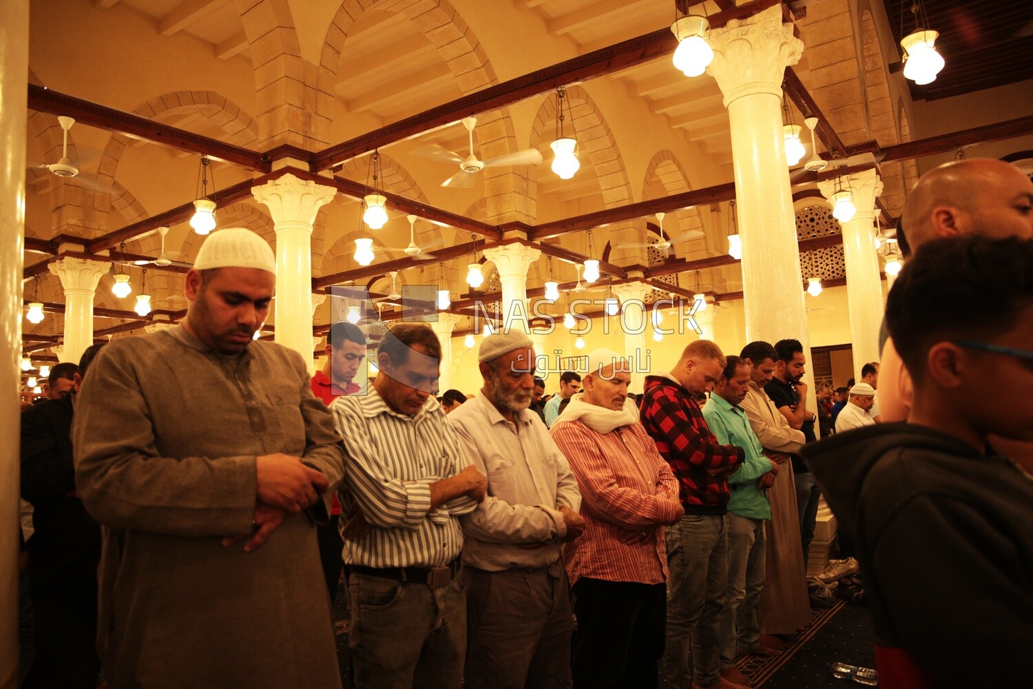 Worshipers praying in a mosque, performing the obligatory prayer in the mosque, worship and draw close to God