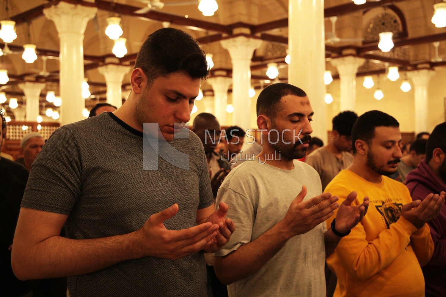 Worshipers praying in a mosque, performing the obligatory prayer in the mosque, worship and draw close to God
