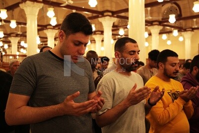 Worshipers praying in a mosque, performing the obligatory prayer in the mosque, worship and draw close to God