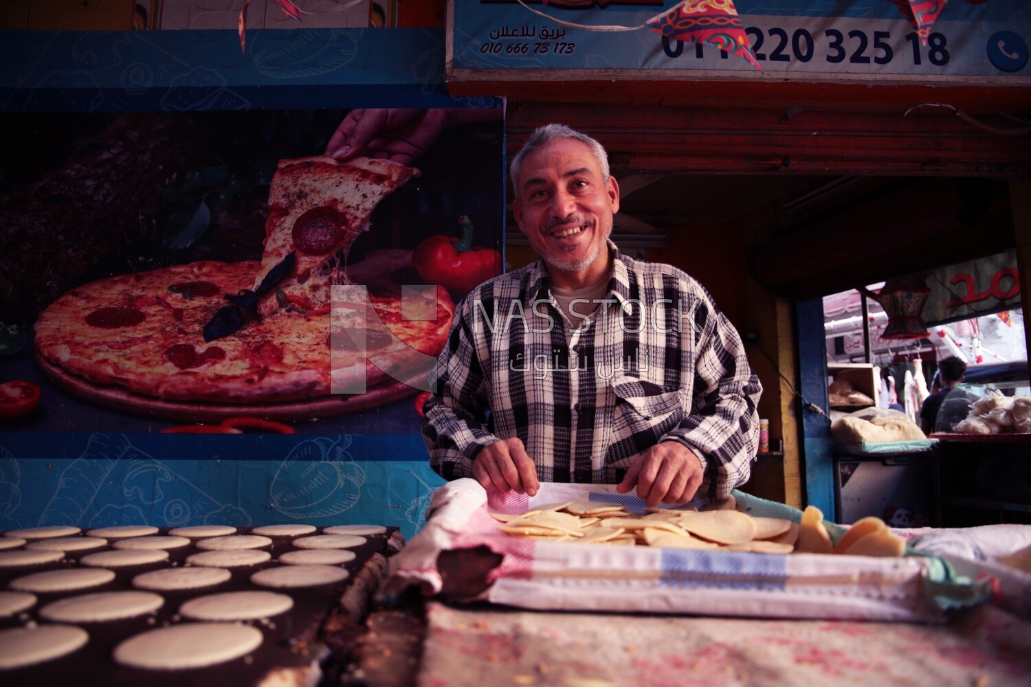 Man standing in qatayef store, Ramadan sweets, Ramadan Kareem