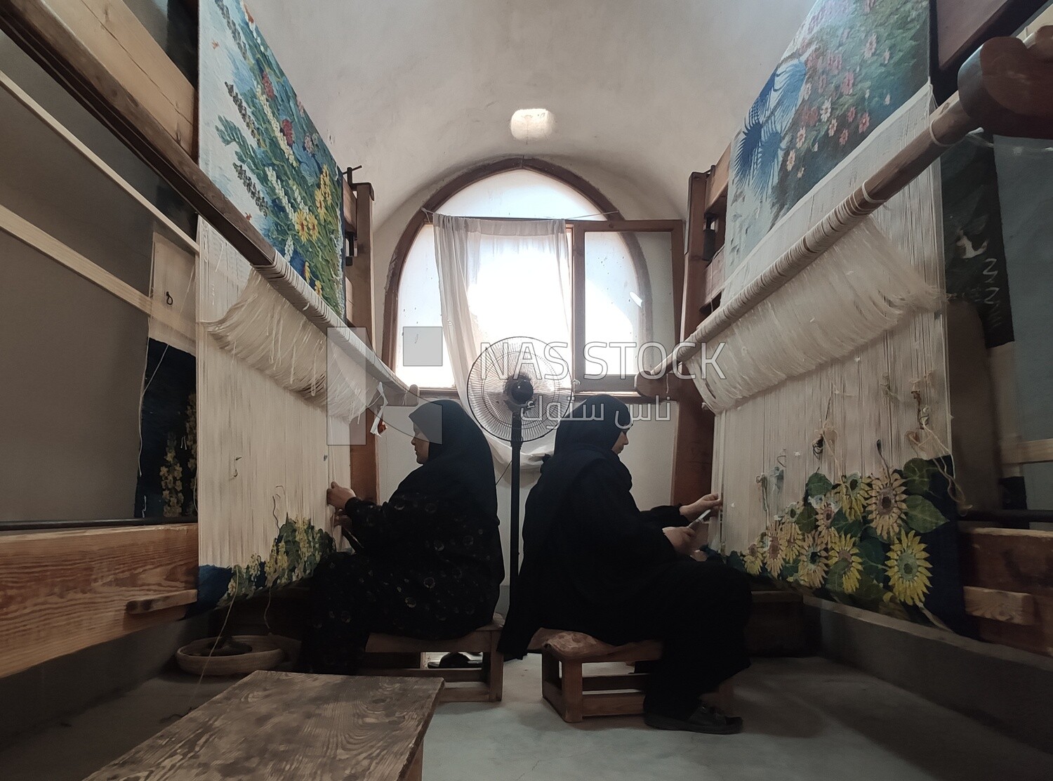 Two Egyptian women weave wall carpets inside the Ramses Wissa Wassef Centre