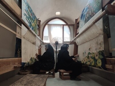 Two Egyptian women weave wall carpets inside the Ramses Wissa Wassef Centre