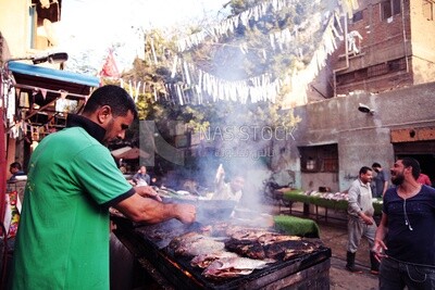 Man grilling fish, street food, Ramadan Kareem