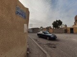 Car drives by on Mamalik Street in the City of the Dead, Egypt