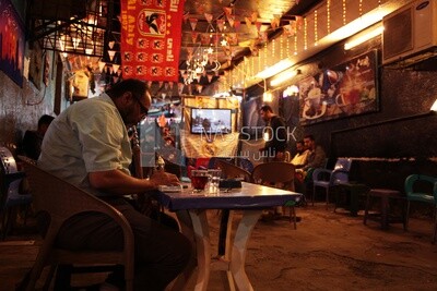 People sitting in a street coffee shop, Ramadan