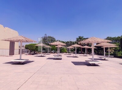 Large garden with benches and umbrellas to protect from the sun