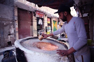 Man standing in Kanafa store, Ramadan sweets, Ramadan Kareem