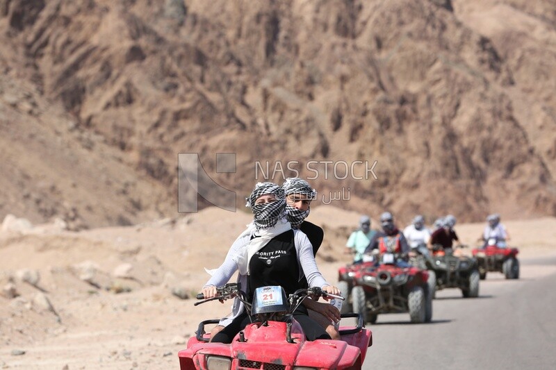 Group of tourists riding a quad bike from the city of Dahab to Wadi Jana,Egypt