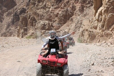 Girl rides a quad bike and enjoys a safari