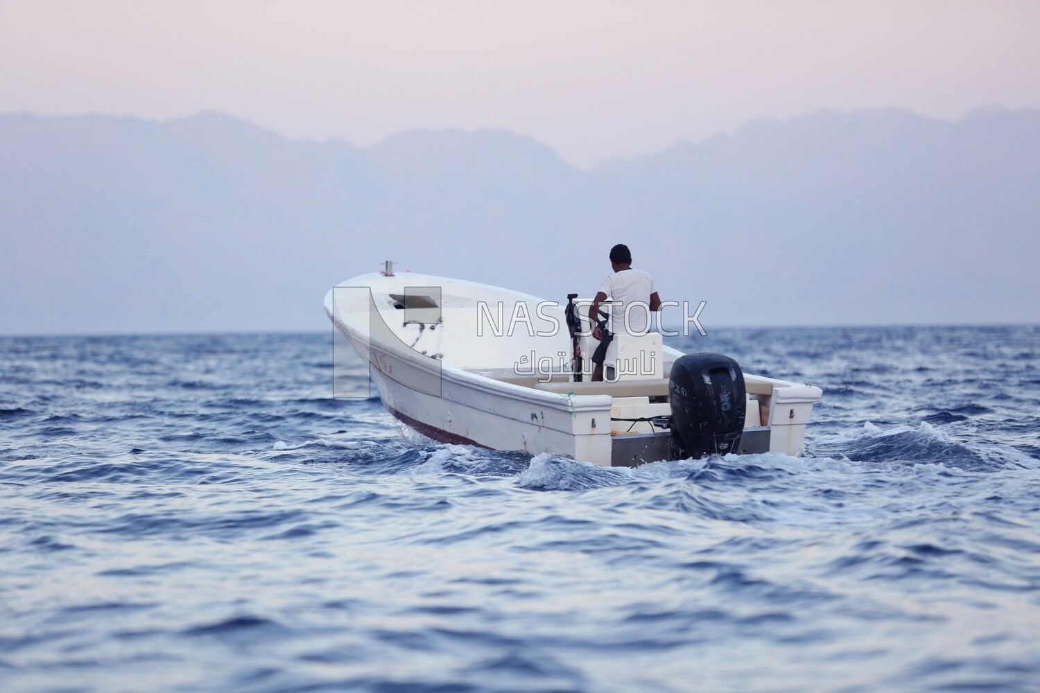 Young man sailing on a yacht in the Red Sea