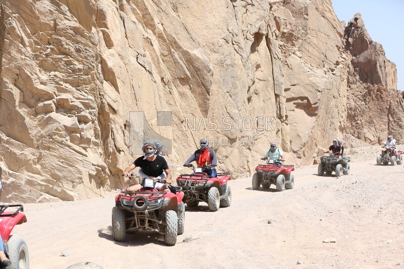 Group of tourists riding a quad bike from the city of Dahab to Wadi Jana,Egypt