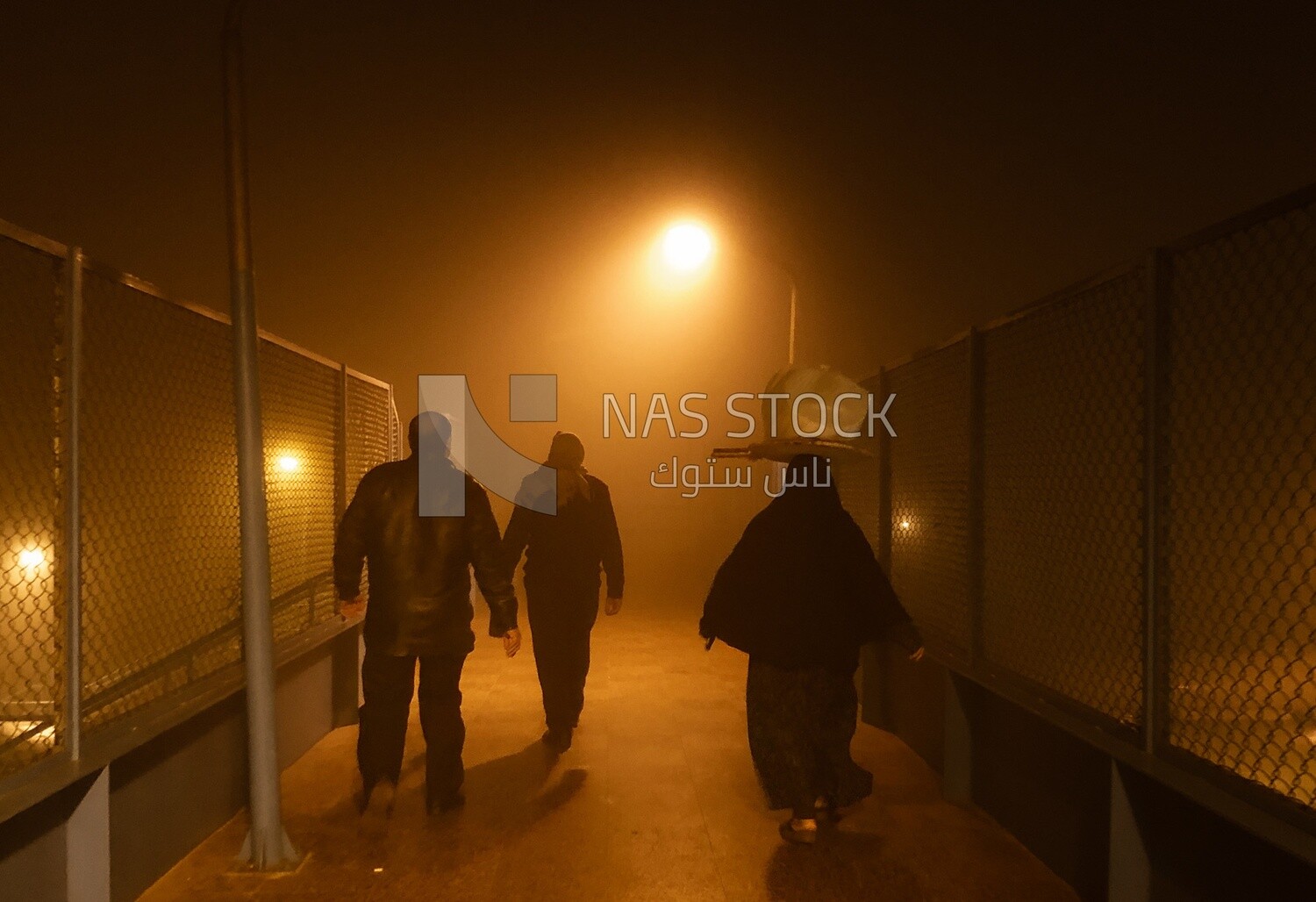 Group of citizens walking in the evening in foggy weather, Shaboura