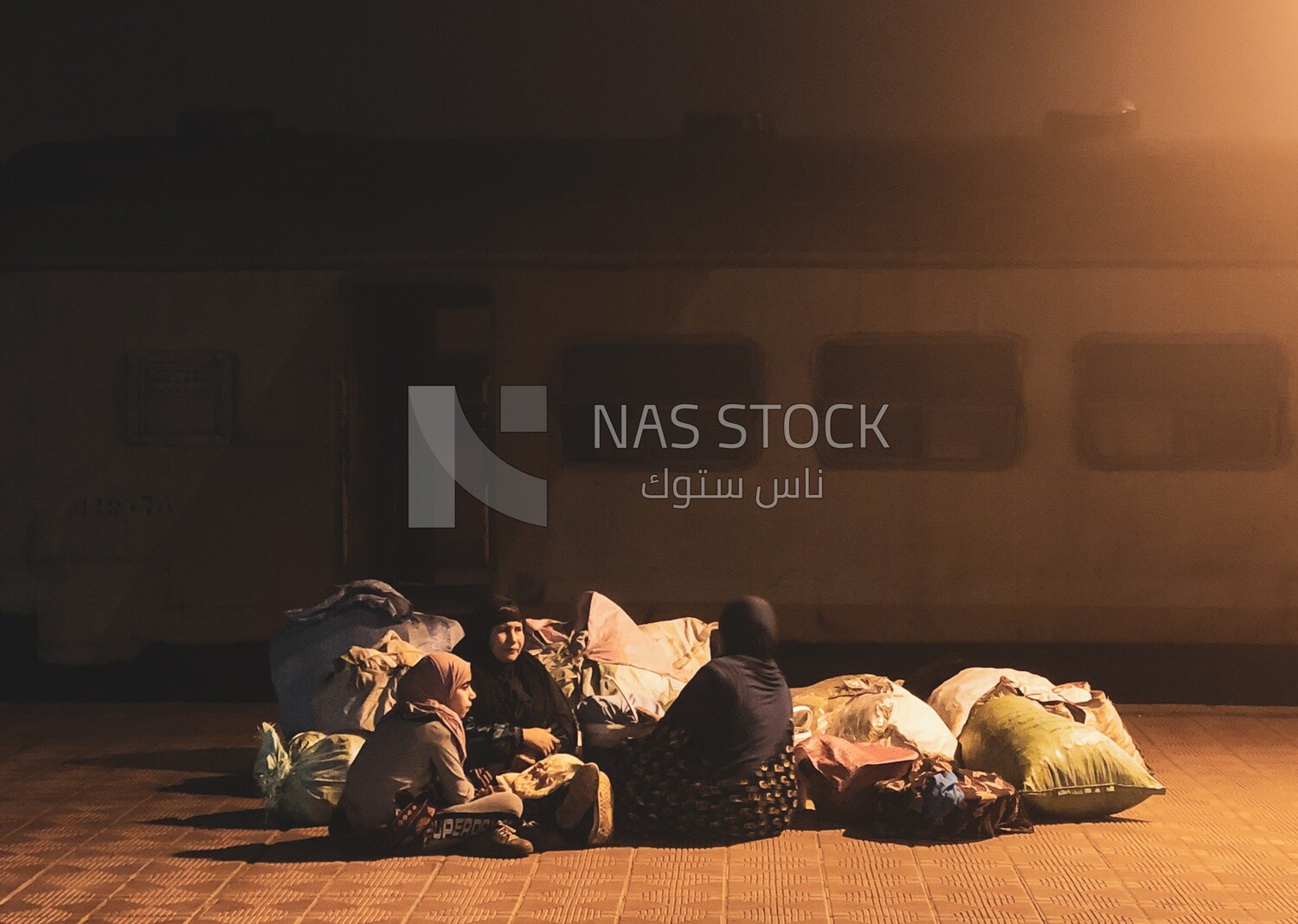 Group of rural women sitting at the train station