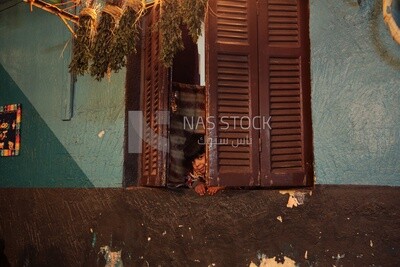 Boy looking from the window, old building