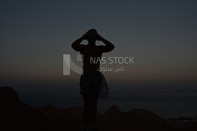 Woman practices yoga in a quiet area near the sea