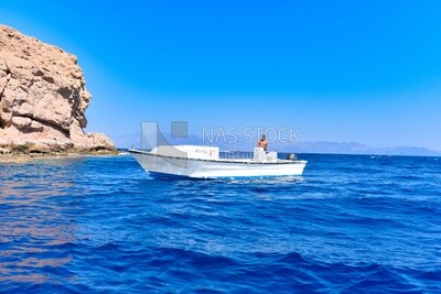 Guy sailing a boat in the Red Sea, Dahab, Egypt.
