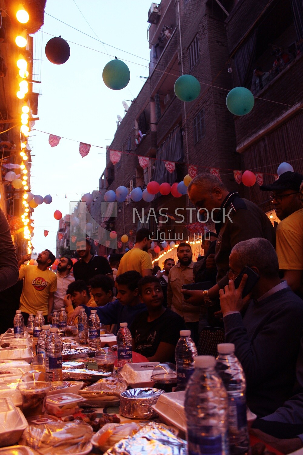 View of people in Matareya sharing their iftar together in the street, Ramadan Kareem, preparing their iftar